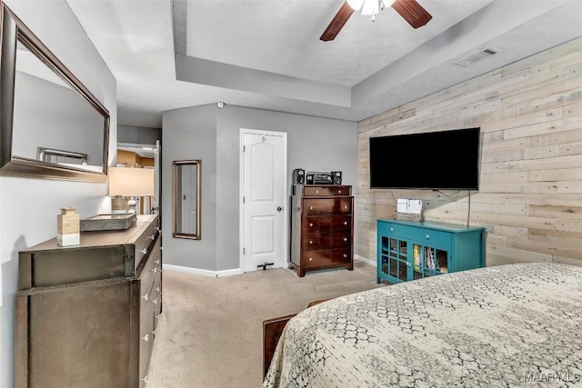 8049 Copperfield Dr, Montgomery, AL 36117 - bedroom featuring light colored carpet, wood walls, ceiling fan, and a tray ceiling