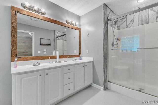 8049 Copperfield Dr, Montgomery, AL 36117 - bathroom featuring a shower stall, tile patterned flooring, and double vanity