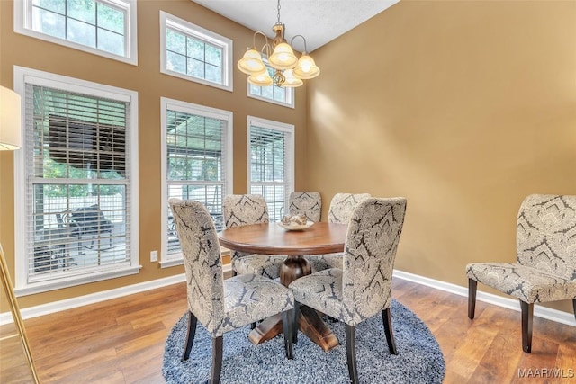 8049 Copperfield Dr, Montgomery, AL 36117 - dining area with a chandelier, light wood-type flooring, and a high ceiling