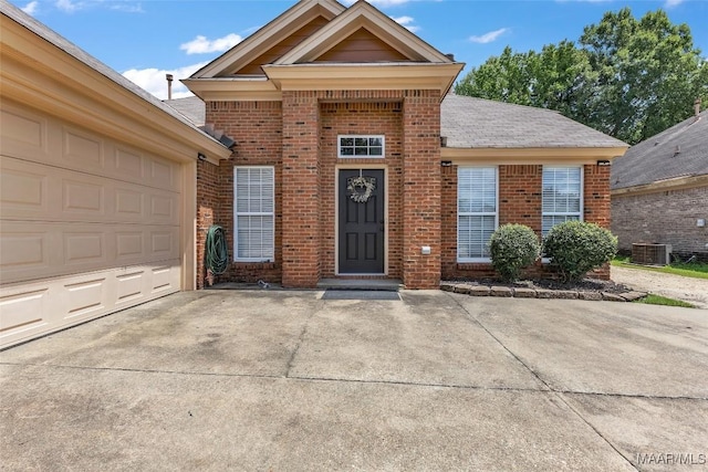 8049 Copperfield Dr, Montgomery, AL 36117 - view of front of property featuring brick siding, an attached garage, concrete driveway, and roof with shingles