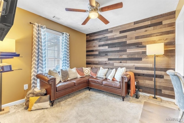 8049 Copperfield Dr, Montgomery, AL 36117 - living area featuring wood walls, a ceiling fan, and carpet floors
