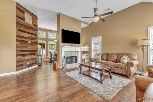8049 Copperfield Dr, Montgomery, AL 36117 - living area featuring high vaulted ceiling, ceiling fan, a fireplace, and dark wood-type flooring