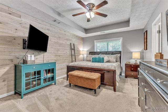 8049 Copperfield Dr, Montgomery, AL 36117 - carpeted bedroom with wooden walls, a textured ceiling, a raised ceiling, and ceiling fan