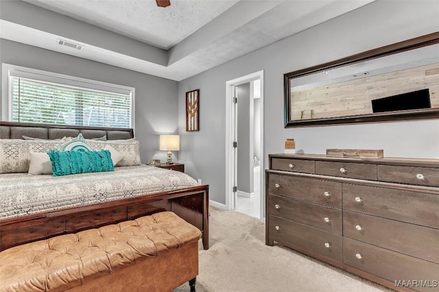 8049 Copperfield Dr, Montgomery, AL 36117 - bedroom with light carpet, a textured ceiling, a tray ceiling, and a ceiling fan