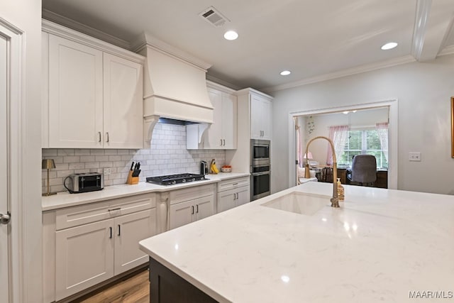 311 Alston Dr, Wetumpka, AL 36093 - kitchen featuring appliances with stainless steel finishes, crown molding, decorative backsplash, white cabinetry, and light stone counters