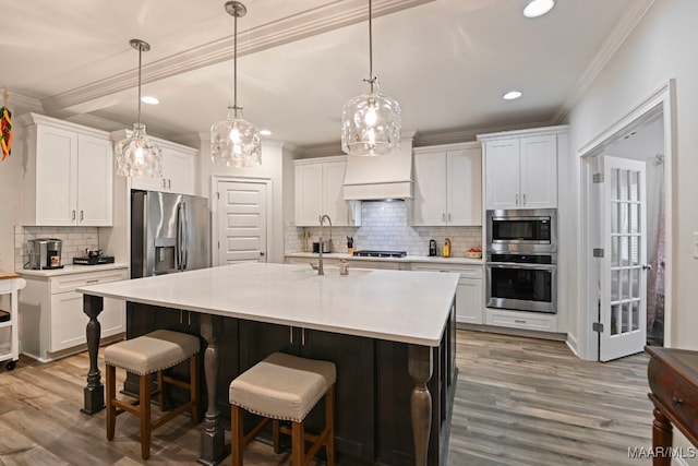 311 Alston Dr, Wetumpka, AL 36093 - kitchen featuring appliances with stainless steel finishes, ornamental molding, tasteful backsplash, wood finished floors, and white cabinetry