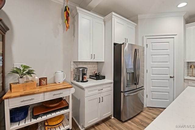 311 Alston Dr, Wetumpka, AL 36093 - kitchen featuring stainless steel refrigerator with ice dispenser, ornamental molding, light countertops, decorative backsplash, and wood finished floors