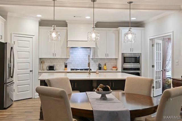 311 Alston Dr, Wetumpka, AL 36093 - kitchen featuring stainless steel appliances, white cabinets, light wood-type flooring, light countertops, and recessed lighting