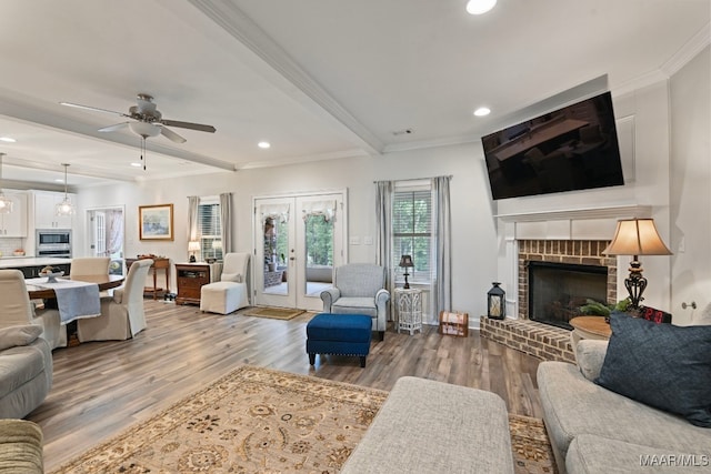 311 Alston Dr, Wetumpka, AL 36093 - living area with a fireplace, french doors, wood finished floors, beam ceiling, and crown molding