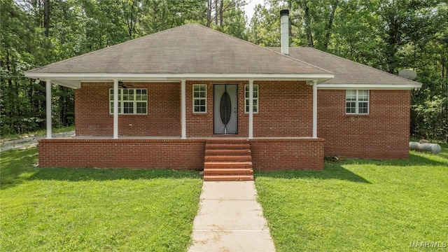 215 Hunters Rd, Eclectic, AL 36024 - single story home with roof with shingles, a front lawn, covered porch, and brick siding