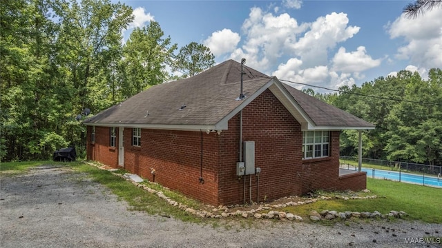 215 Hunters Rd, Eclectic, AL 36024 - view of property exterior with brick siding and roof with shingles
