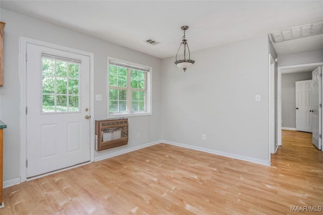 215 Hunters Rd, Eclectic, AL 36024 - unfurnished dining area with heating unit and light wood-type flooring