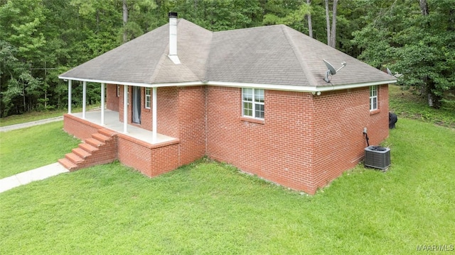 215 Hunters Rd, Eclectic, AL 36024 - view of side of home featuring a lawn, a chimney, brick siding, and a shingled roof