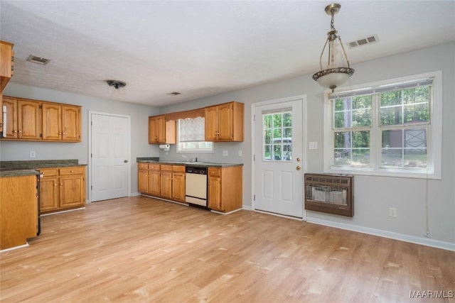 215 Hunters Rd, Eclectic, AL 36024 - kitchen with dishwashing machine, heating unit, light wood-style flooring, brown cabinetry, and dark countertops