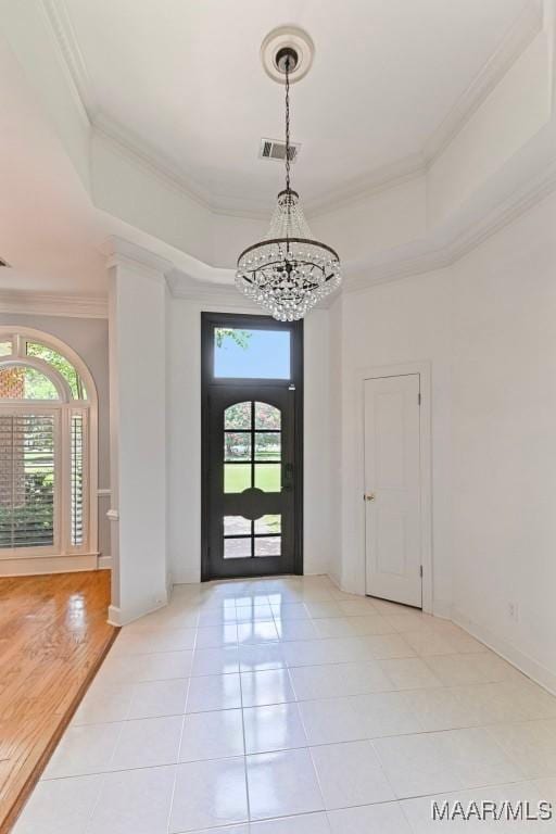 7930 Mossy Oak Dr, Montgomery, AL 36117 - entrance foyer featuring a chandelier, plenty of natural light, a raised ceiling, and ornamental molding