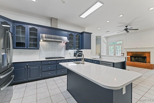 7930 Mossy Oak Dr, Montgomery, AL 36117 - kitchen with wall chimney exhaust hood, appliances with stainless steel finishes, ornamental molding, light tile patterned floors, and backsplash