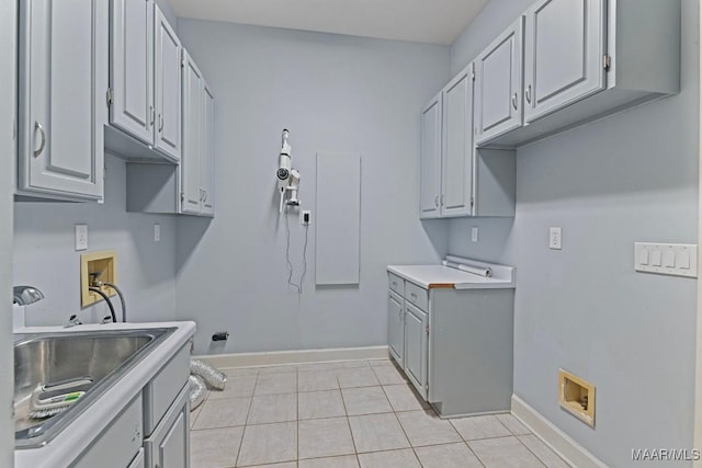 7930 Mossy Oak Dr, Montgomery, AL 36117 - laundry area featuring hookup for a washing machine, cabinet space, and light tile patterned floors