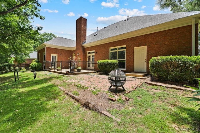 7930 Mossy Oak Dr, Montgomery, AL 36117 - back of house with a fire pit, brick siding, a chimney, a deck, and a patio