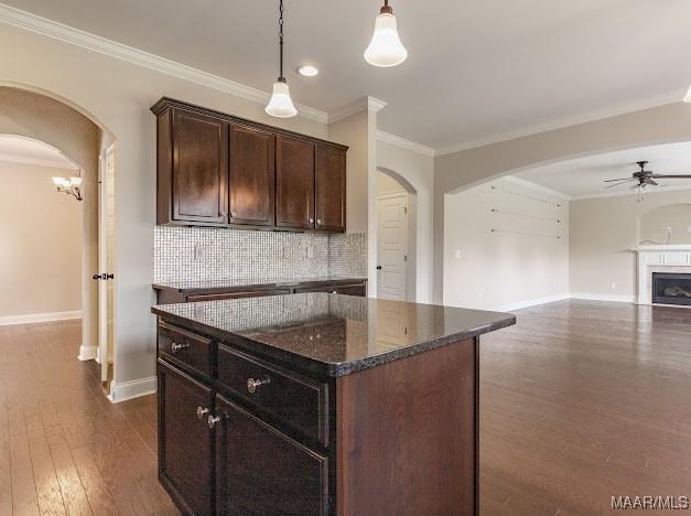 1531 Wingate Park Ct, Montgomery, AL 36117 - kitchen with arched walkways, ceiling fan, ornamental molding, dark wood finished floors, and decorative backsplash