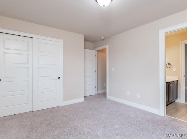 1531 Wingate Park Ct, Montgomery, AL 36117 - unfurnished bedroom with light colored carpet, a closet, and connected bathroom
