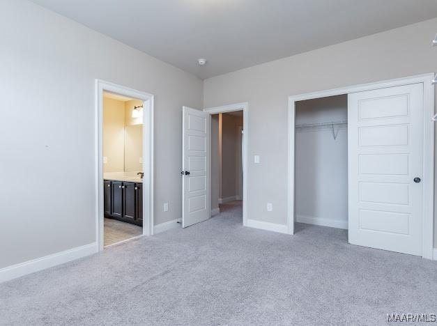 1531 Wingate Park Ct, Montgomery, AL 36117 - unfurnished bedroom with light colored carpet, a closet, and ensuite bath