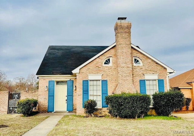 1604 Salisbury Dr, Montgomery, AL 36117 - view of front of home with a chimney, a front yard, and a shingled roof
