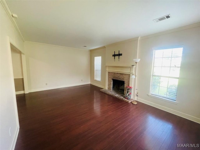 1604 Salisbury Dr, Montgomery, AL 36117 - unfurnished living room featuring crown molding, dark wood-type flooring, and a fireplace