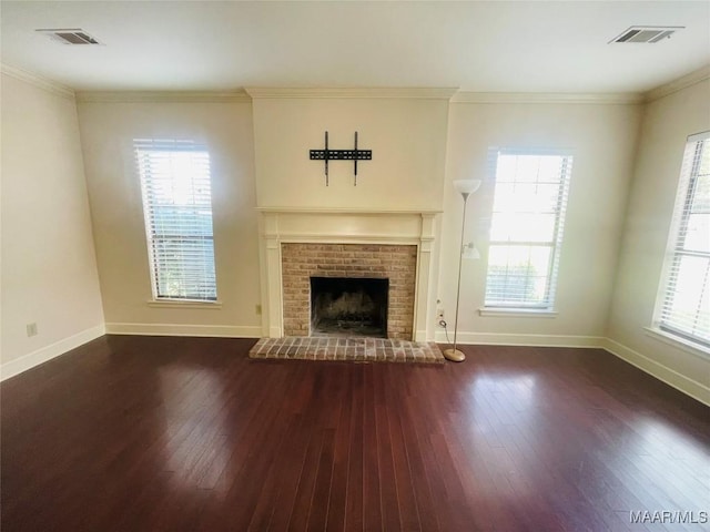 1604 Salisbury Dr, Montgomery, AL 36117 - unfurnished living room featuring wood-type flooring, ornamental molding, and a brick fireplace