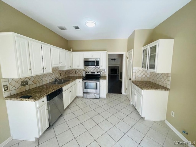 1604 Salisbury Dr, Montgomery, AL 36117 - kitchen featuring stainless steel appliances, backsplash, and white cabinetry