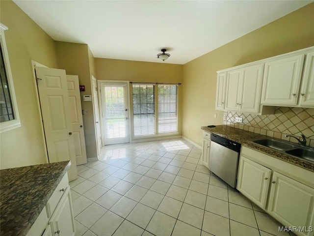 1604 Salisbury Dr, Montgomery, AL 36117 - kitchen with stainless steel dishwasher, light tile patterned floors, backsplash, and white cabinets