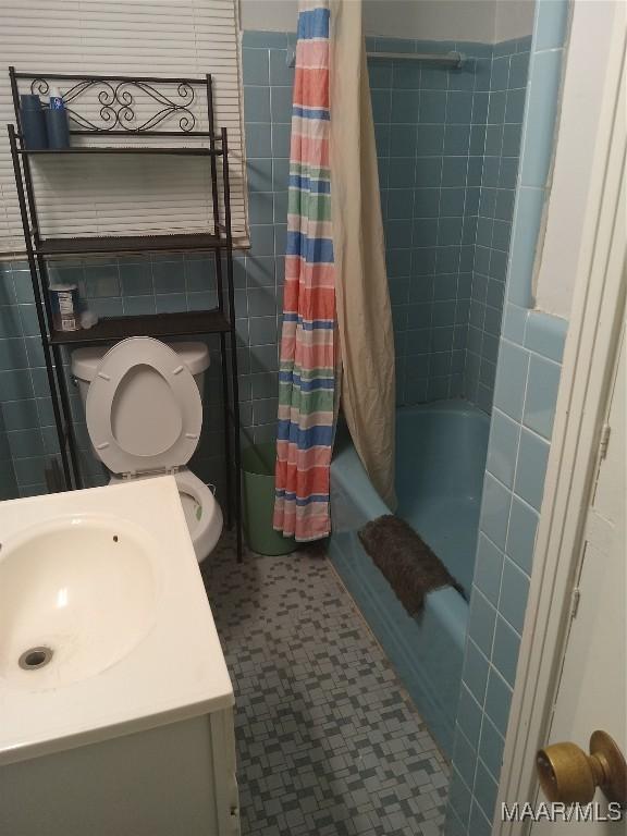304 Patterson St, Tuskegee, AL 36088 - bathroom featuring tile walls, shower / bath combo, vanity, and tile patterned floors