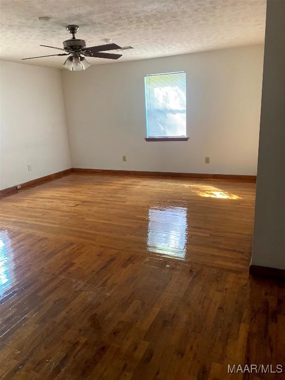 304 Patterson St, Tuskegee, AL 36088 - spare room with hardwood / wood-style flooring, ceiling fan, and a textured ceiling