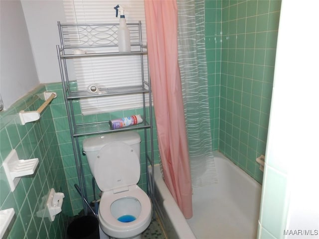 304 Patterson St, Tuskegee, AL 36088 - bathroom with tile walls and shower / tub combo with curtain