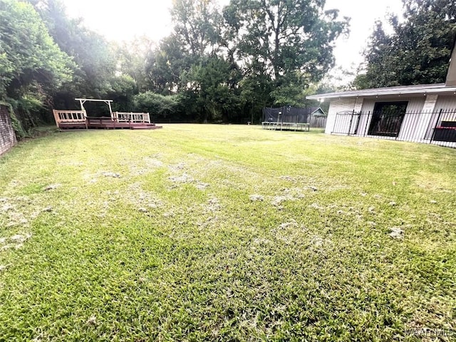 3628 Bankhead Ave, Montgomery, AL 36111 - view of yard with a trampoline and a deck