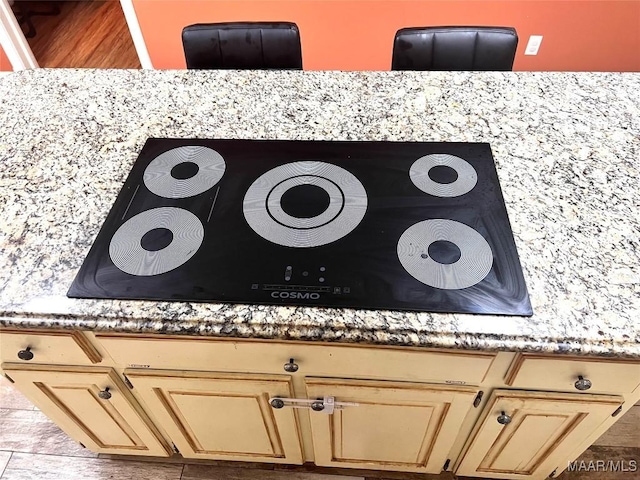 3628 Bankhead Ave, Montgomery, AL 36111 - kitchen view of black electric stovetop, light countertops, and wood finished floors