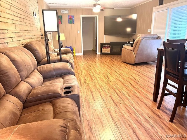 3628 Bankhead Ave, Montgomery, AL 36111 - living room featuring wood finished floors, crown molding, ceiling fan, and a fireplace