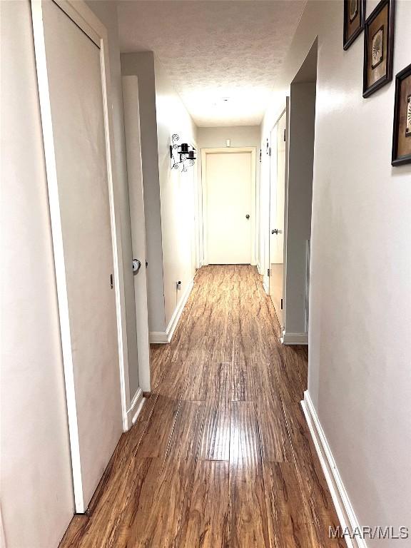 3628 Bankhead Ave, Montgomery, AL 36111 - corridor featuring wood finished floors and a textured ceiling