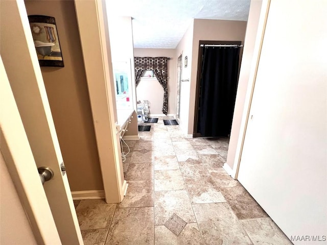 3628 Bankhead Ave, Montgomery, AL 36111 - corridor featuring a textured ceiling and light stone finish flooring