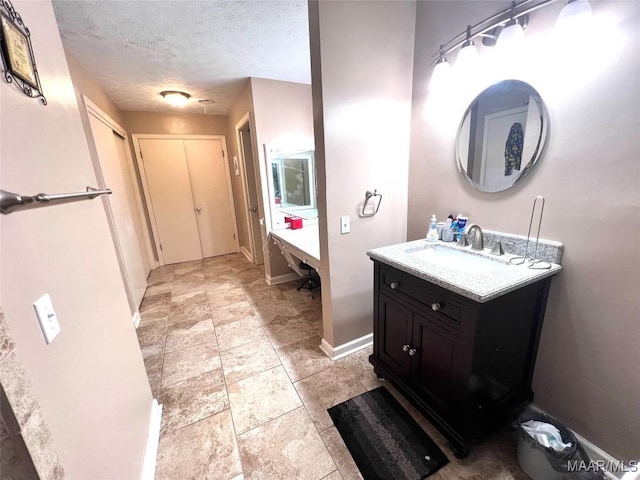 3628 Bankhead Ave, Montgomery, AL 36111 - bathroom with vanity, a textured ceiling, and stone finish floors