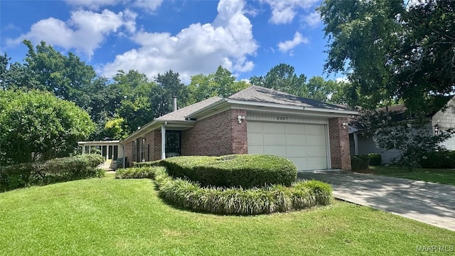 6537 Monmouth Mews, Montgomery, AL 36117 - view of side of property with brick siding, driveway, a lawn, and an attached garage
