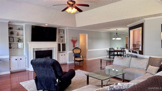 6537 Monmouth Mews, Montgomery, AL 36117 - living area with a textured ceiling, dark wood finished floors, ceiling fan, a fireplace, and a chandelier