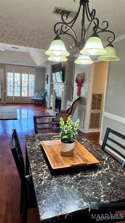 6537 Monmouth Mews, Montgomery, AL 36117 - dining space with a textured ceiling, wood-type flooring, and ornamental molding
