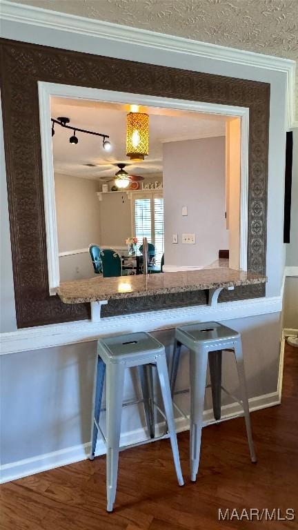 6537 Monmouth Mews, Montgomery, AL 36117 - kitchen with ornamental molding, wood finished floors, track lighting, and a kitchen bar