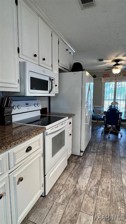 6537 Monmouth Mews, Montgomery, AL 36117 - kitchen with white appliances, dark wood finished floors, a textured ceiling, ceiling fan, and white cabinets