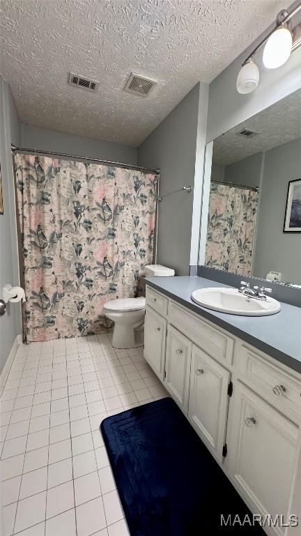 6537 Monmouth Mews, Montgomery, AL 36117 - bathroom featuring vanity, a textured ceiling, and tile patterned flooring