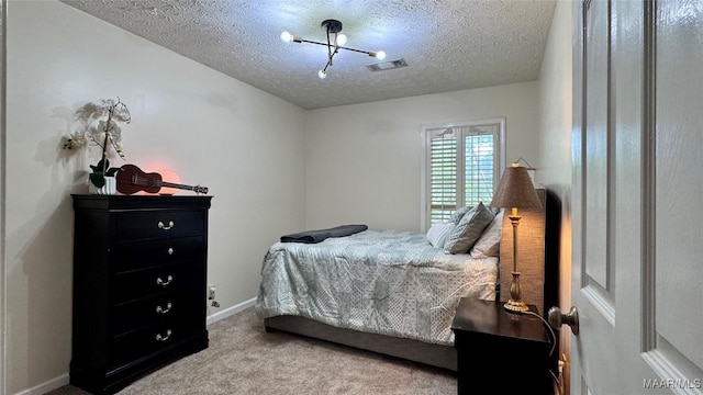 6537 Monmouth Mews, Montgomery, AL 36117 - bedroom with a textured ceiling, carpet floors, and a chandelier