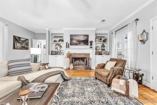 9021 Creek Side Trl, Hope Hull, AL 36043 - living room with wood finished floors, crown molding, a fireplace, and built in features