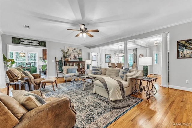 9021 Creek Side Trl, Hope Hull, AL 36043 - living room with a chandelier, plenty of natural light, a ceiling fan, decorative columns, and crown molding