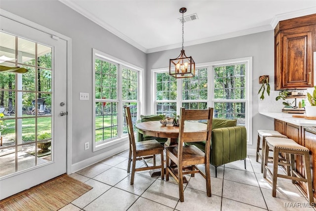 9021 Creek Side Trl, Hope Hull, AL 36043 - dining space with light tile patterned flooring, ornamental molding, and a chandelier