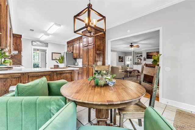 9021 Creek Side Trl, Hope Hull, AL 36043 - dining area with crown molding, light tile patterned flooring, a ceiling fan, and a chandelier